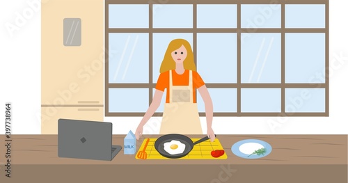 Woman in the kitchen with computer learning to cook online