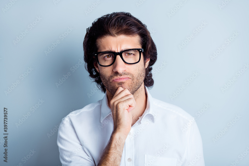 Photo portrait of confused thinking man touching face chin with finger isolated on clear white colored background Photo portrait of confused thinking man touching face chin with finger isolated on clear white colored background