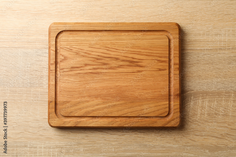 Kitchen board on wooden background, space for text