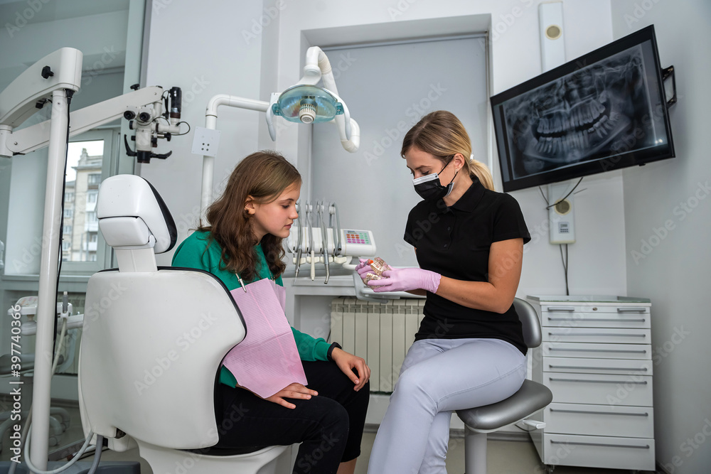 Dentist showing how to brush your teeth on jaws model to patient in dental clinic Dentist showing how to brush your teeth on jaws model to patient in dental clinic
