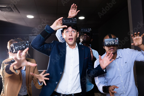 Multiethnic friends using virtual reality glasses - people having fun with new technology vr headset - Main focus on american man - New tech trends concept