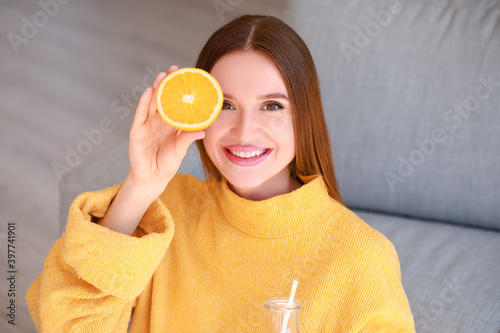 Beautiful young woman drink...