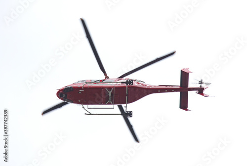 Red helicopter isolated in the sky