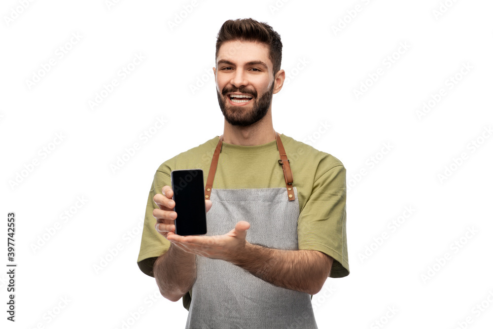 people, technology and job concept - happy smiling barman in apron showing smartphone over white background