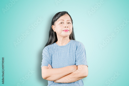 Senior woman folded hands with haughty expression