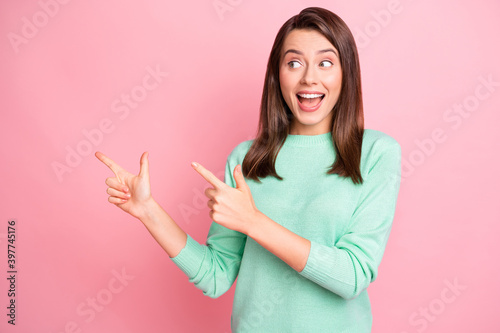 Photo of funny young lady look direct fingers empty space open mouth wear turquoise sweater isolated pink color background © deagreez