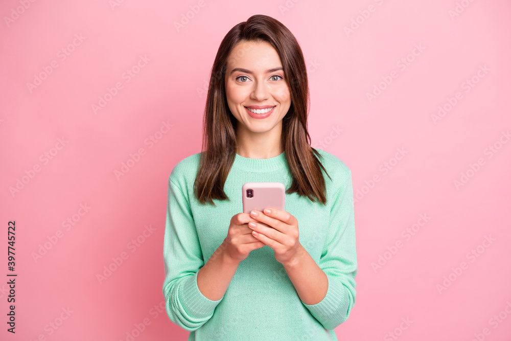 Portrait of attractive young people hands hold phone satisfied teal sweater isolated on pink color background Portrait of attractive young people hands hold phone satisfied teal sweater isolated on pink color background