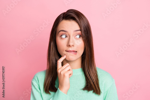 Portrait of attractive person looking empty space bite lips arm finger on chin sweater isolated on pink color background