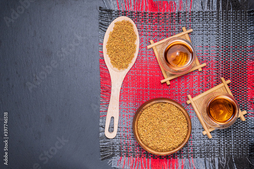 Tea of fenugreek, seeds on a wooden surface. relief from anemia, loss of taste, fever, alternative medicine photo