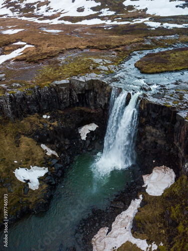 Waterfall in the mountains in East Iceland in winter