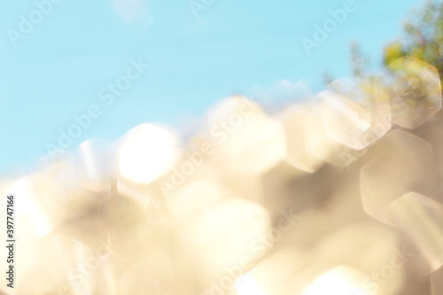 Soft lights hexagon bokeh background. Golden and blue background. Pastel colors, holidays concept.