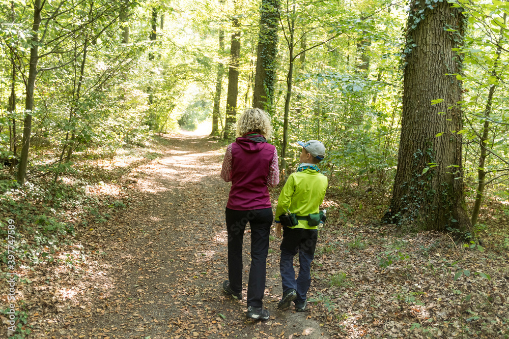Mother with child geocaching in the forest Mother with child geocaching in the forest