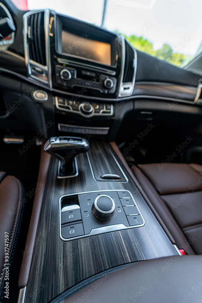 Modern supercar interior with leather panel, sport seats, multimedia and digital dashboard. Closeup.