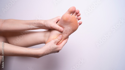 massage of leg muscles with hands, leg pain