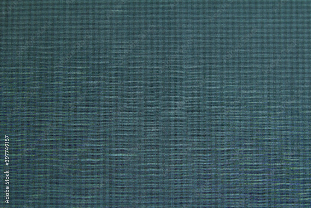 Background made of wool fabric in a small check of green-gray color for the autumn-winter wardrobe. Horizontal orientation Background made of wool fabric in a small check of green-gray color for the autumn-winter wardrobe. Horizontal orientation
