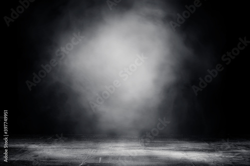 Empty space of Studio dark room concrete floor grunge texture background with spot lighting and fog or mist.