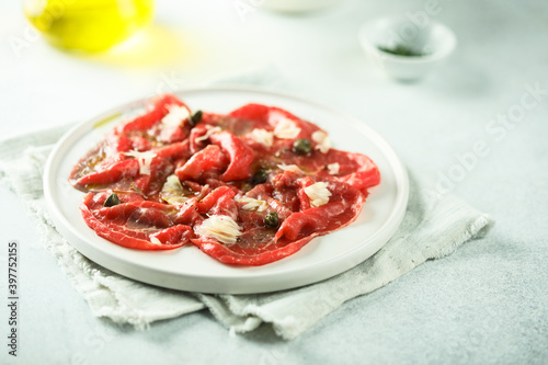 Traditional beef carpaccio on a white plate