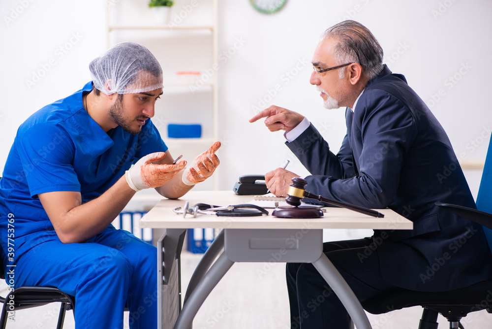 Male doctor in courthouse meeting with advocate