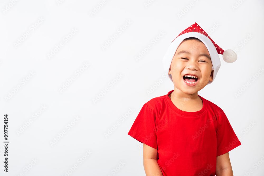 Portrait of Asian little cute boy smile and excited, Kid dressed in red Santa Claus hat the concept of holiday Christmas Xmas day or Happy new year, studio shot isolated on white backgroun Portrait of Asian little cute boy smile and excited, Kid dressed in red Santa Claus hat the concept of holiday Christmas Xmas day or Happy new year, studio shot isolated on white backgroun