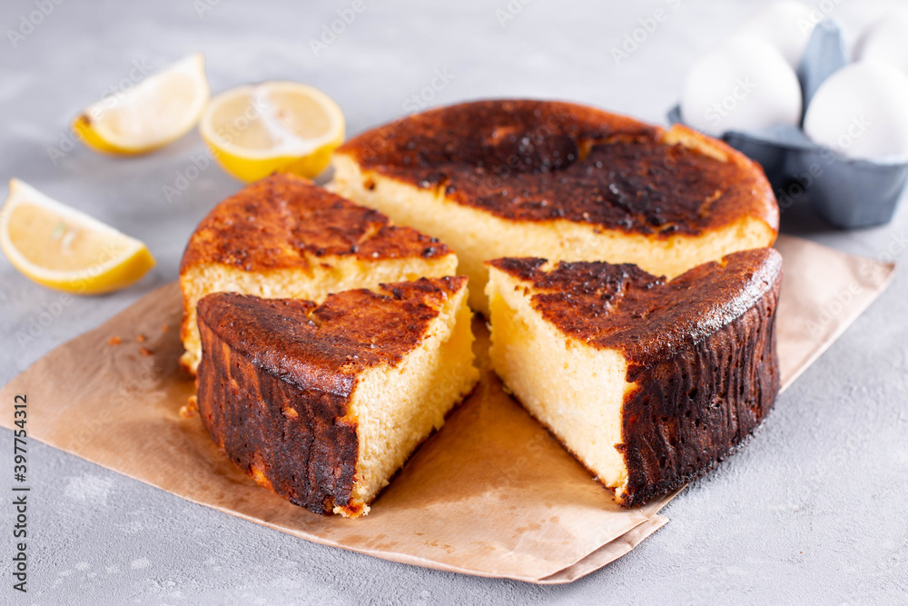 San Sebastian cheesecake cut and sliced for serving on a background San Sebastian cheesecake cut and sliced for serving on a background