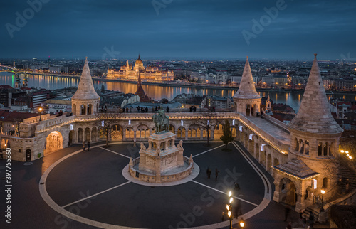 Budapest, Hungary - Aerial ciew of the famous Fisherman's Bastion at dusk with Christmas festive lights, statue of King Stephen I and Parliament of Hungary at background on a winter afternoon