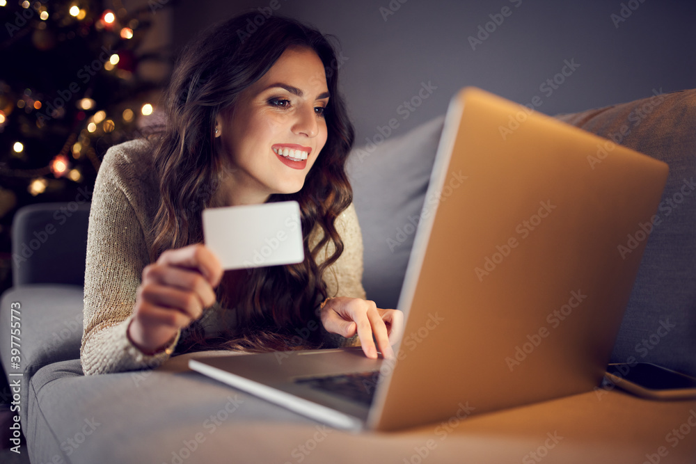 Fototapeta premium Woman shopping online from home during christmas