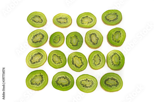 kiwi fruit sliced into circles on a white matte background with a light
