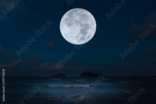 Full moon over sea in the dark night.