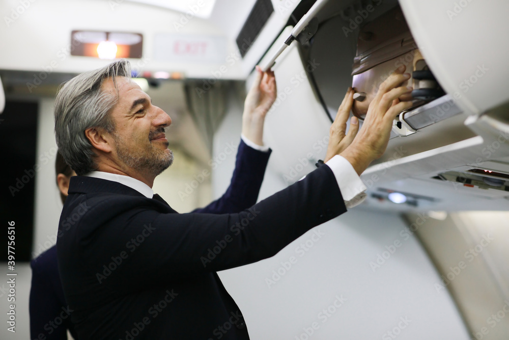 Handluggage compartment with suitcases in airplane. ,Happy flight