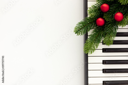 Synthesizer with Christmas decor toys and spruce branch. Christmas music.