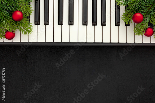 Synthesizer with Christmas decor toys and spruce branch. Christmas music.