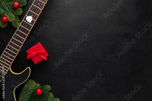 Christmas music. Flat lay composition with guitar and fir tree branches