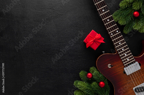 Christmas music. Flat lay composition with guitar and fir tree branches