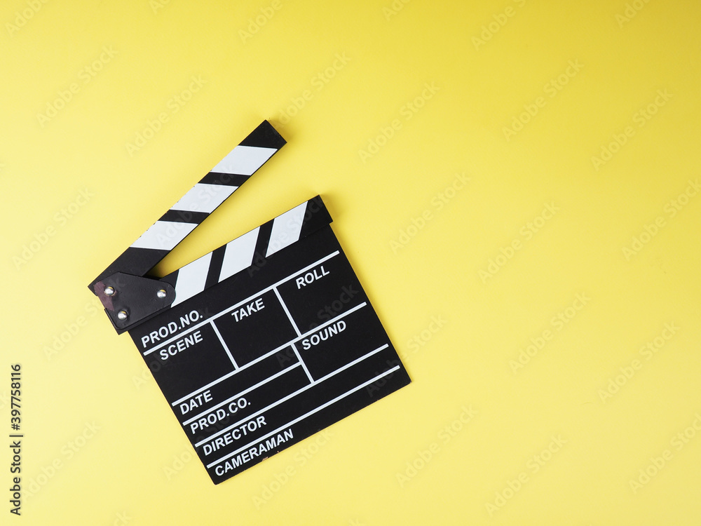 the concept of the film industry, a minimalistic composition on a yellow background with glasses and clapperboard. movies and cinema.