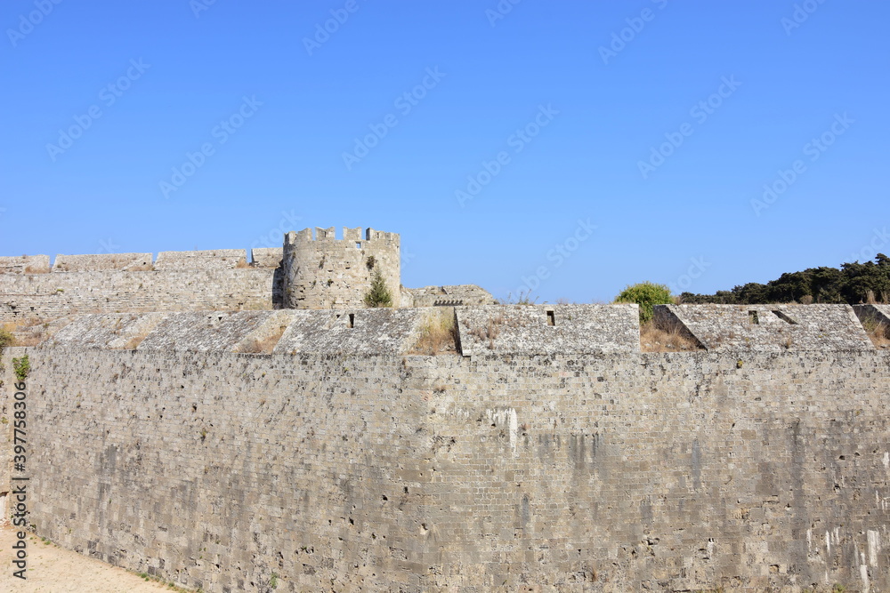 A view of the ancient walls of the old town of Rhodes on the Greek island of Rhodes on a summer holiday day.