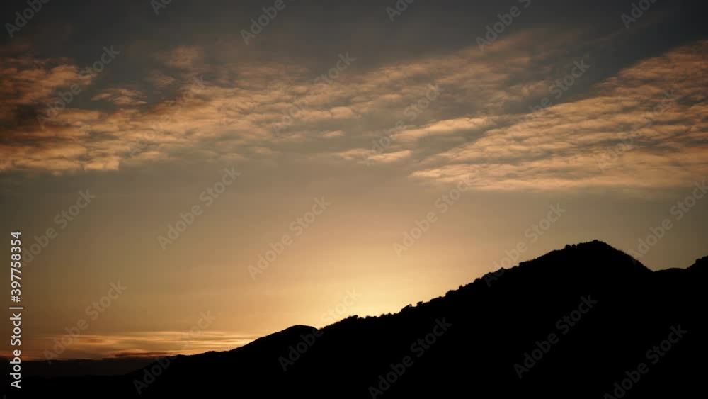 Sunset over coast. Sun sinking below hilly land. Nature landscape. Time lapse Sunset over coast. Sun sinking below hilly land. Nature landscape. Time lapse