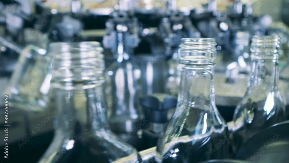 Empty glass bottles are being relocated by a transporter Empty glass bottles are being relocated by a transporter