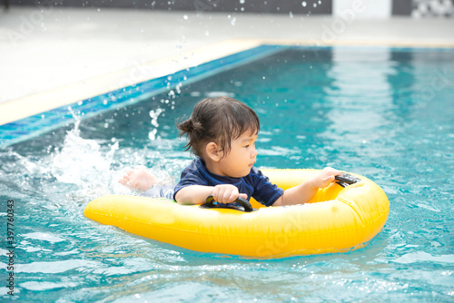 little girl swimming in the pool in inflatable boat © winai