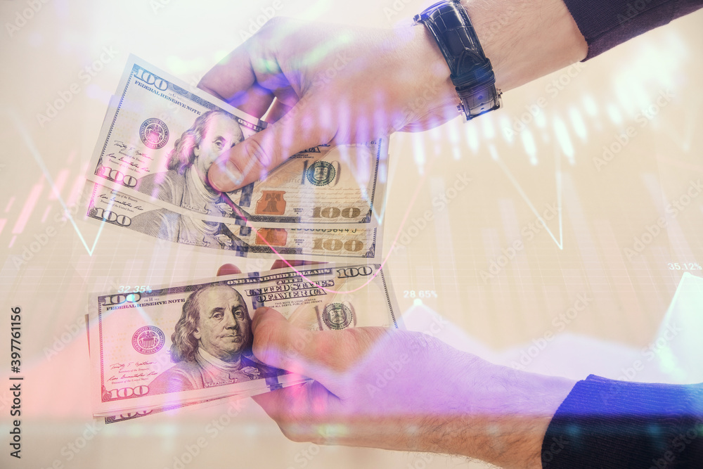 Multi exposure of financial graph drawing hologram and USA dollars bills and man hands. Analysis concept. Multi exposure of financial graph drawing hologram and USA dollars bills and man hands. Analysis concept.