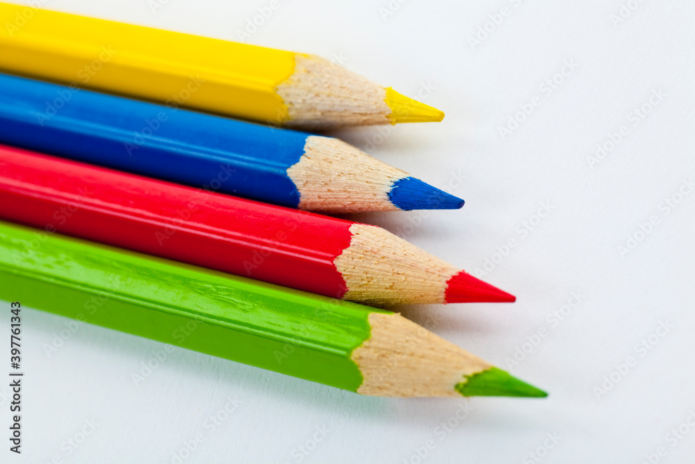 Four pencils, green, yellow, blue and red. Studio photo isolated on white background. Four pencils, green, yellow, blue and red. Studio photo isolated on white background.