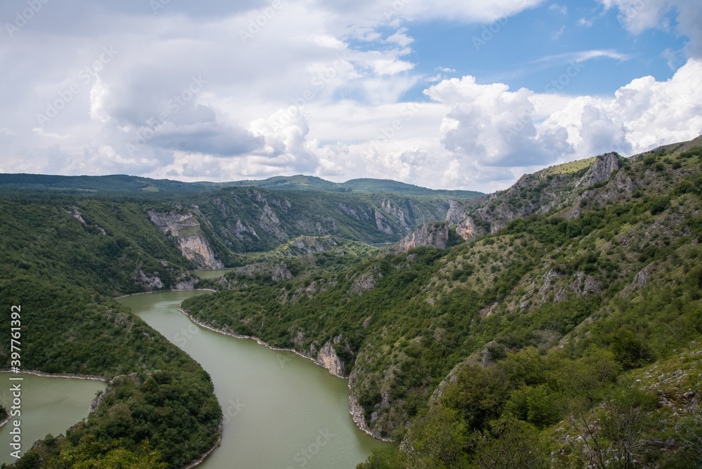 Scenic canyon view of meanders on the river Uvac, on the Zlatar Mountain,with beautiful sky in the background.Uvac is a special nature reserve in Serbia with endangered bird species Griffon Vulture.