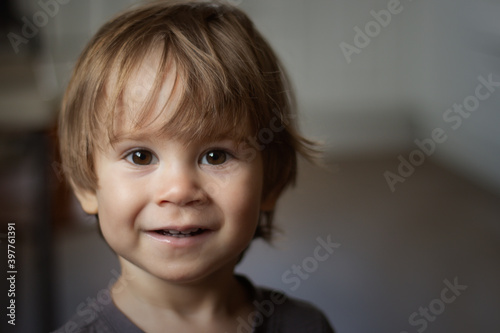 Portrait of a kid with big eyes, close up, smiling, emotional