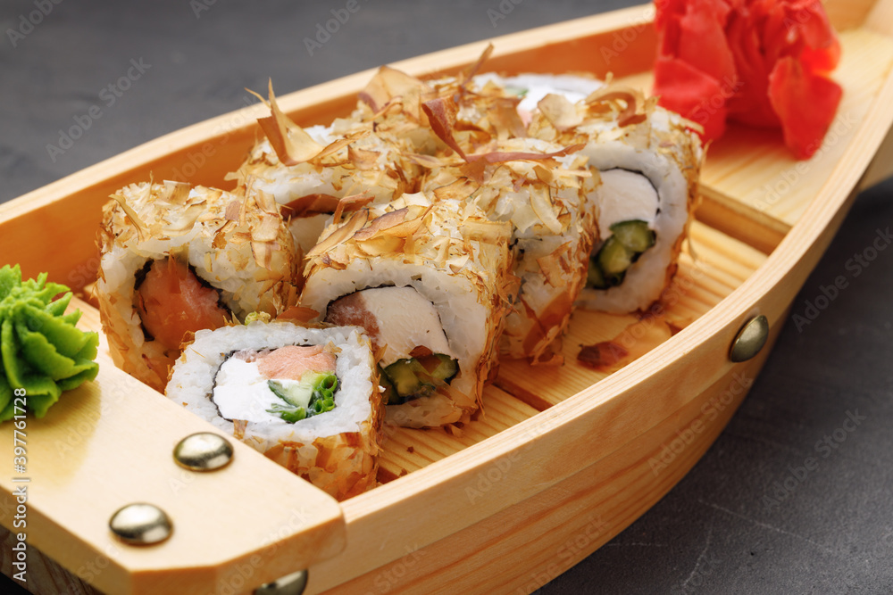 Sushi roll with tuna shavings on plate close up Sushi roll with tuna shavings on plate close up