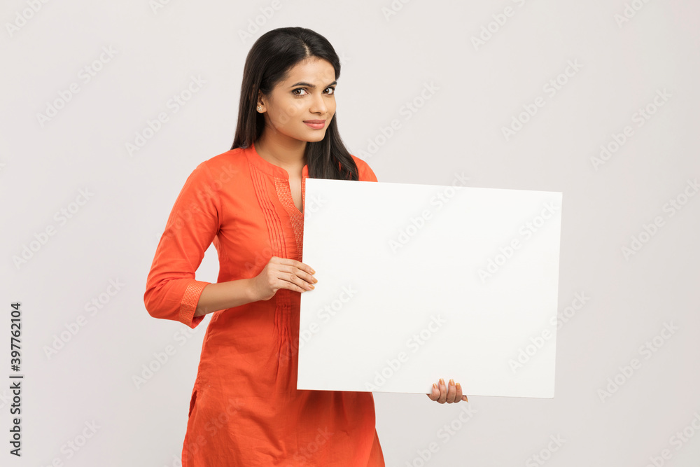 Cheerful attractive young women holding white board on white. Cheerful attractive young women holding white board on white.
