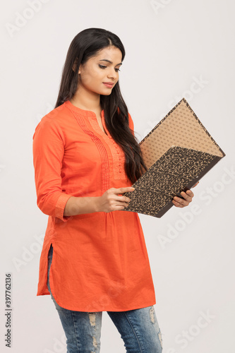 Canvas Print Indian young woman with files on white.