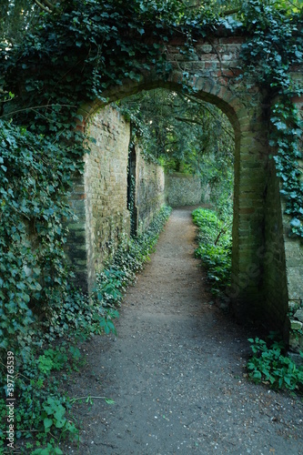 Fototapeta Naklejka Na Ścianę i Meble -  Entrance to the path near the stream. Walking path in Essex in Saffron Walden.