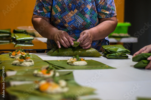 Wrapping tamales Latin American dish.