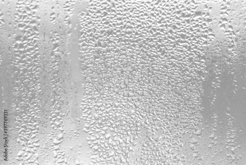 Water drops on glass. Gray abstract wall background.
