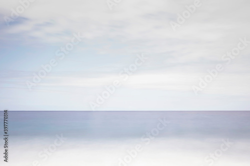 Blue ocean and shore under cloudy sky. Ocean in a bad weather. Ocean in winter 
