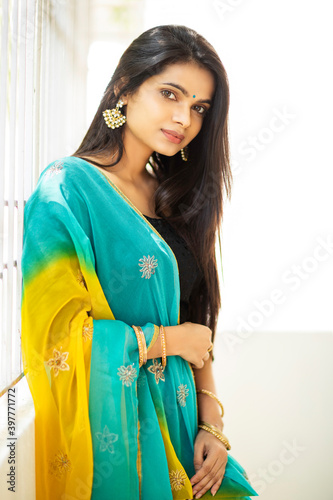 Photography Pretty Indian young woman in traditional dress on white.